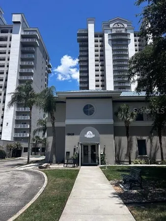 a front view of a building with a garden