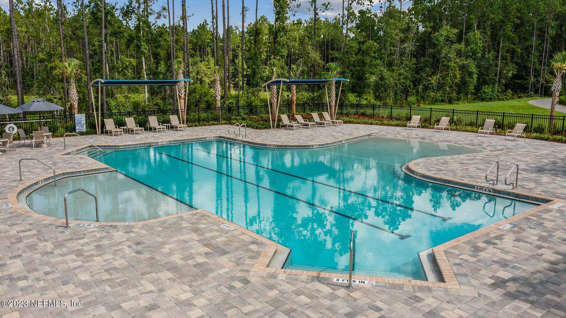 48 Barley Street St. Augustine, FL 32092 - Photo 22 of 37 a view of a swimming pool with a patio and garden
