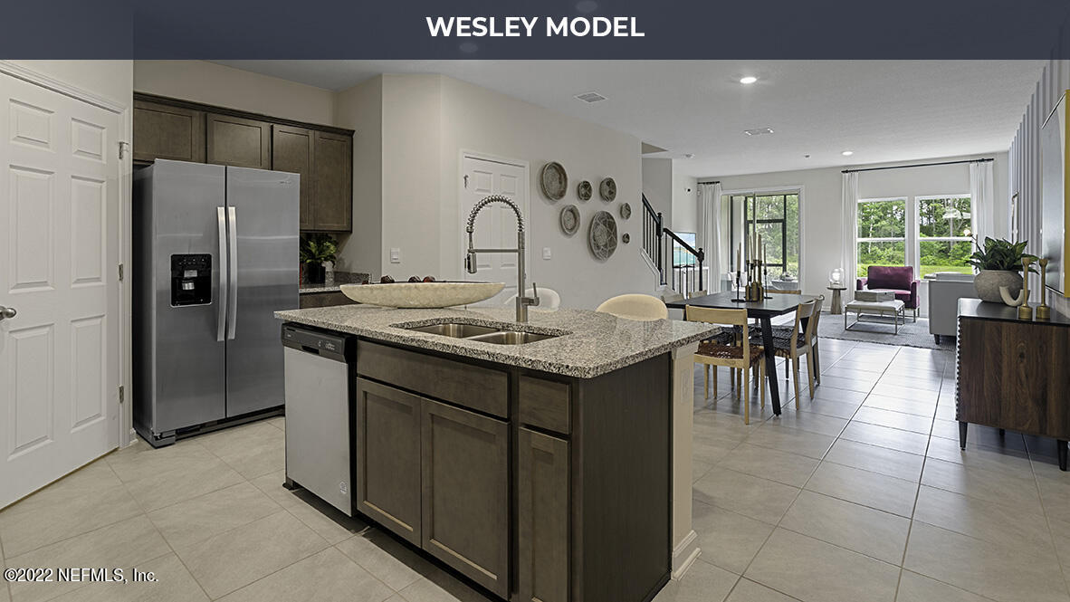 48 Barley Street St. Augustine, FL 32092 - Photo 5 of 37 a kitchen with stainless steel appliances granite countertop a sink a stove and a refrigerator