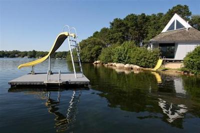 222 Hayes Road Centerville, MA 02632 - Photo 5 of 23 a view of a wooden deck and lake view