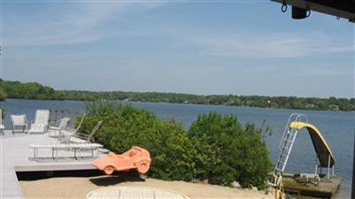 222 Hayes Road Centerville, MA 02632 - Photo 7 of 23 a view of a lake with couches and wooden fence