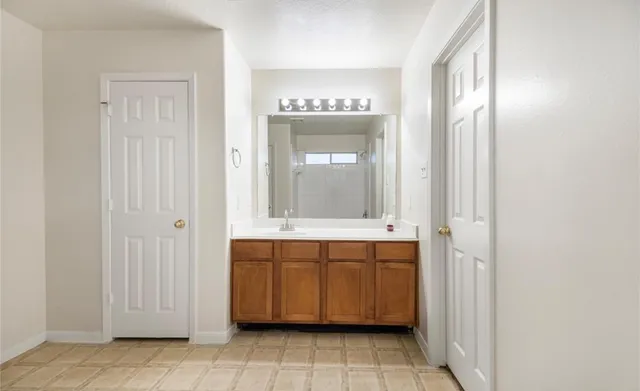 a spacious bathroom with a mirror a sink and a bathtub