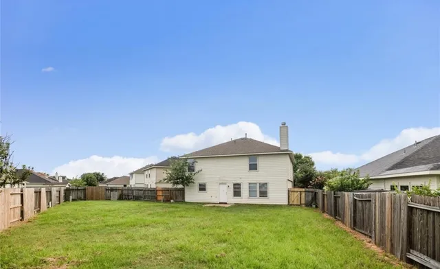 a view of a house with a yard and sitting area