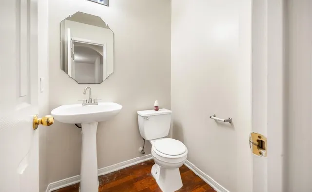 a bathroom with a sink toilet and mirror