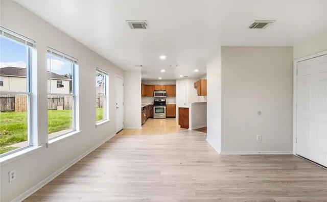 a view of a kitchen with furniture and a large window