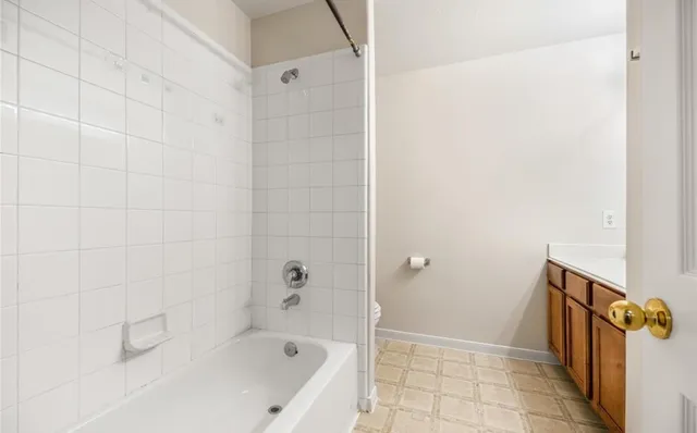 a bathroom with a bathtub and shower