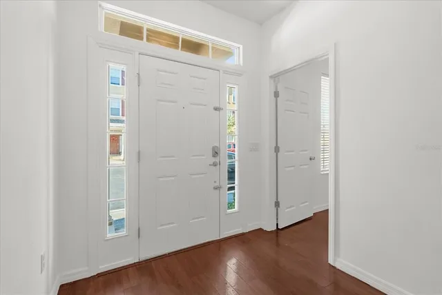 an empty room with wooden floor & closet