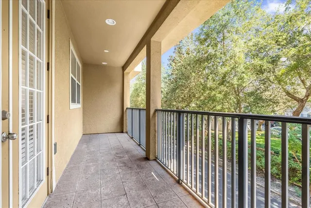 a view of a hallway with wooden floor and fence