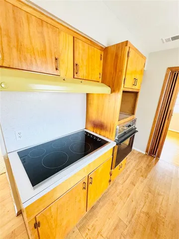 a view of kitchen and wooden floor