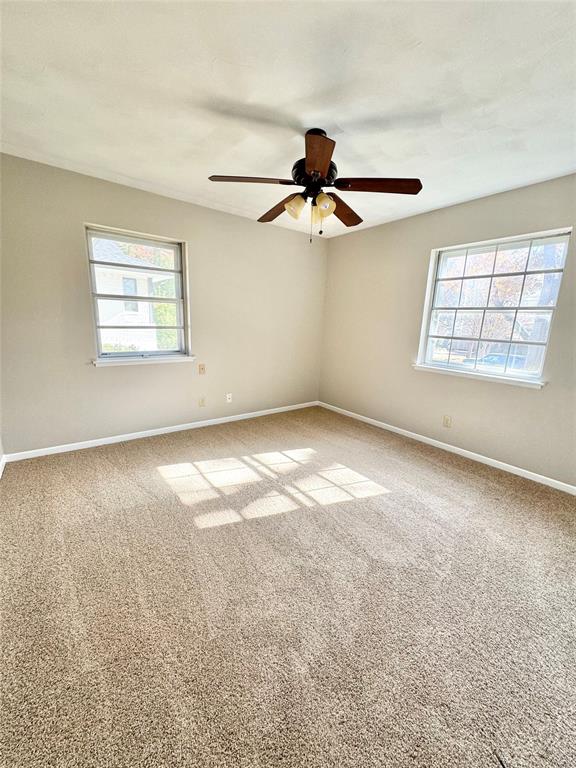2261 Springhill Drive Dallas, TX 75228 - Photo 5 of 12 an empty room with windows and fan