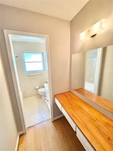 a bedroom with a bed and a mirror