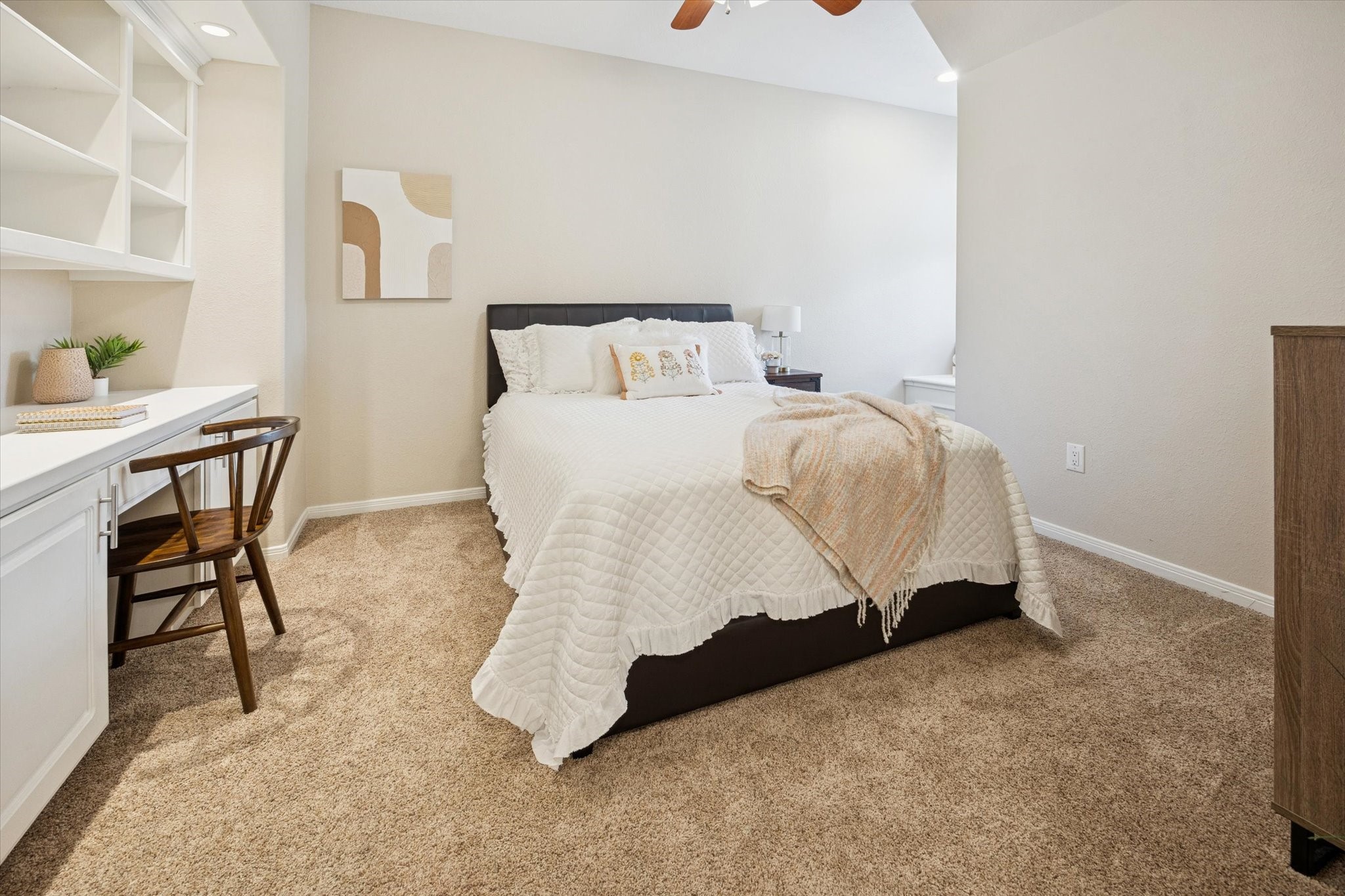 2904 Bridle Path Lane Friendswood, TX 77546 - Photo 32 of 49 At the top of the second-floor stairs, you'll find this first spacious bedroom featuring an en-suite bathroom and a convenient walk-through closet. The room also includes a built-in desk perfect for work or study, along with a charming window seat that doubles as additional storage—ideal for reading or relaxing.