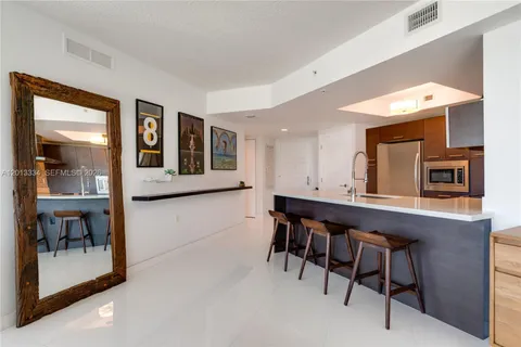 a kitchen with a sink a stove and a refrigerator