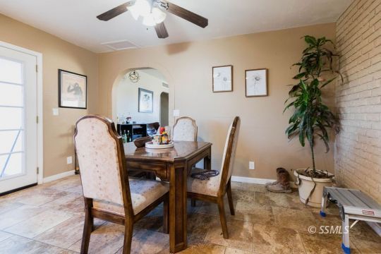 925 West St George Avenue Ridgecrest, CA 93555 - Photo 10 of 24 a view of a dining room with furniture and a potted plant