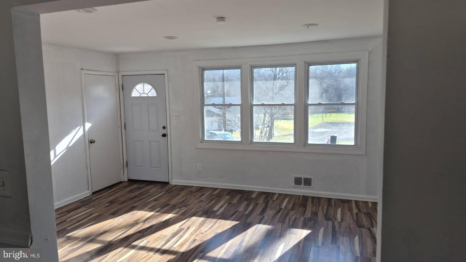 5004 Meadowbrook Drive Suitland, MD 20746 - Photo 2 of 10 a view of empty room with wooden floor and fan