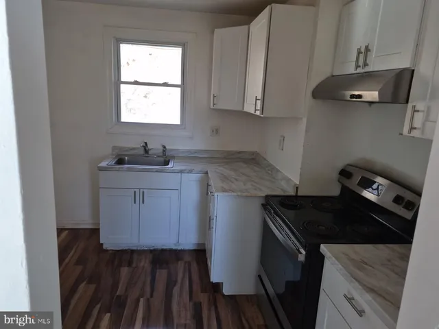 a kitchen with sink cabinets and stove