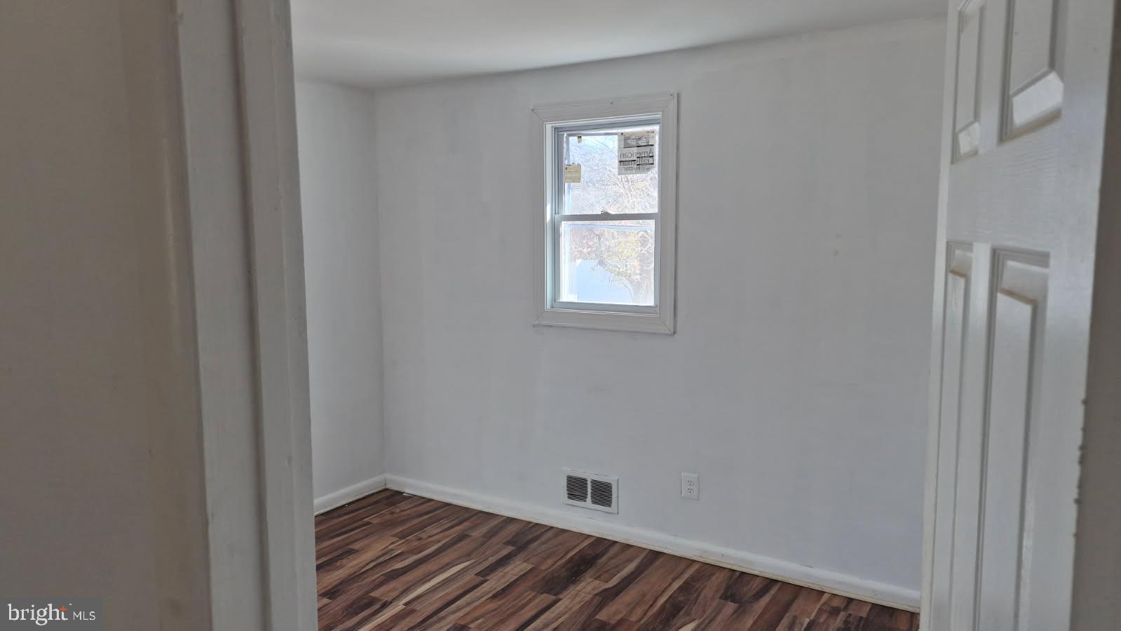 5004 Meadowbrook Drive Suitland, MD 20746 - Photo 6 of 10 a view of an empty room with wooden floor and a window