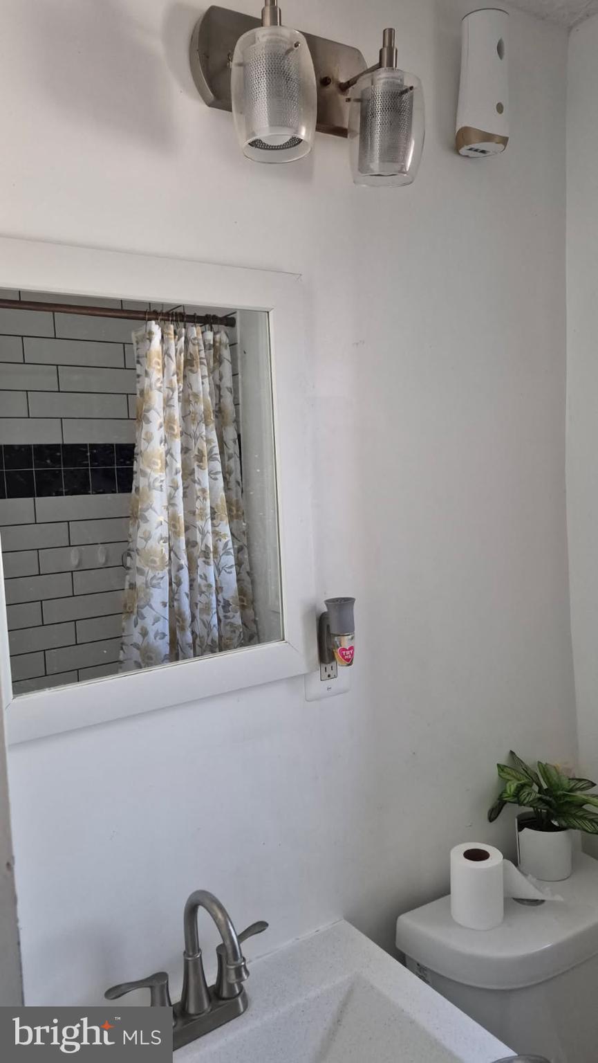 5004 Meadowbrook Drive Suitland, MD 20746 - Photo 8 of 10 a bathroom with a sink and a mirror