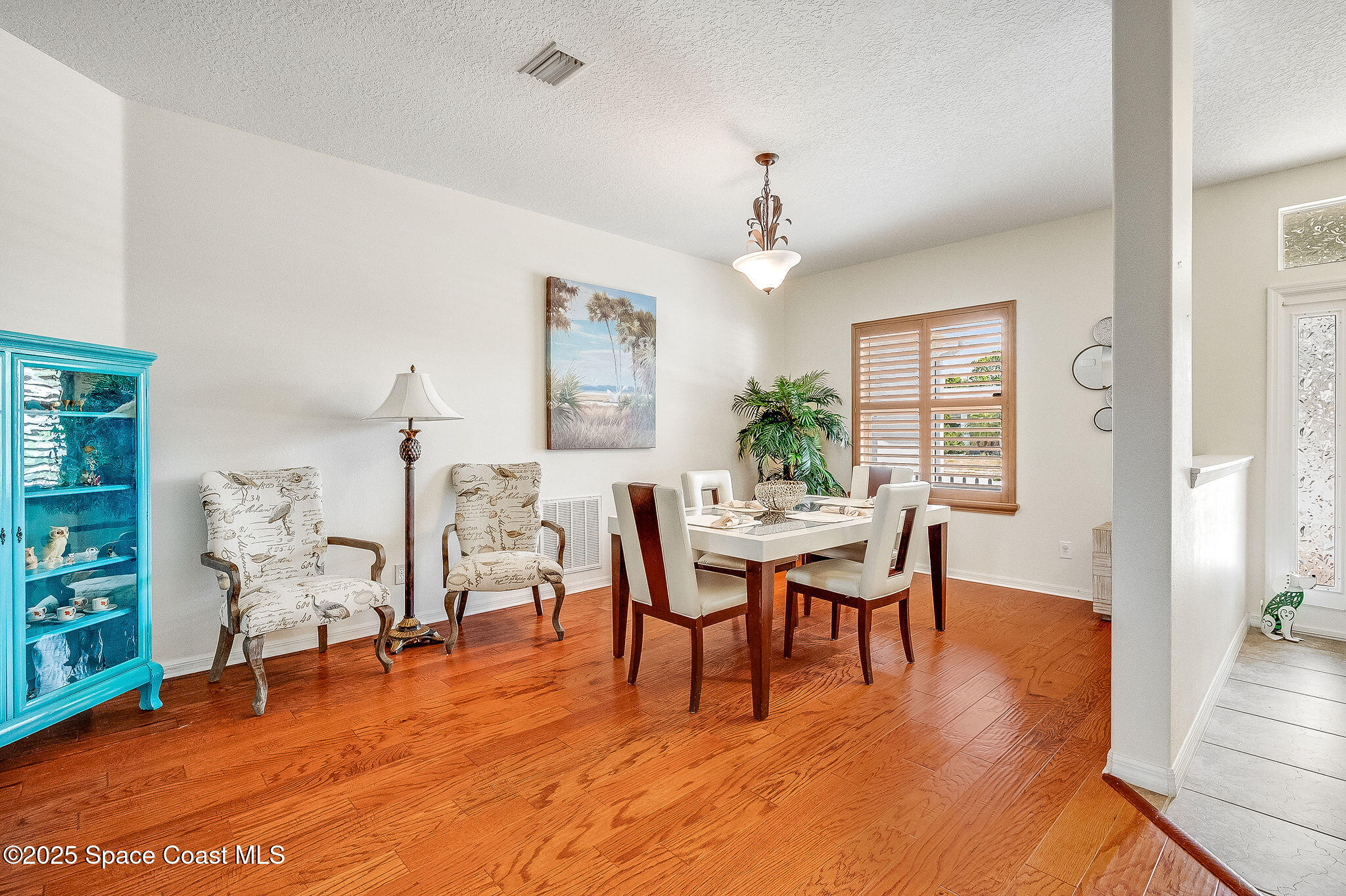 1137 Morgan Circle Northeast Palm Bay, FL 32905 - Photo 10 of 64 a dining room with furniture a chandelier and wooden floor