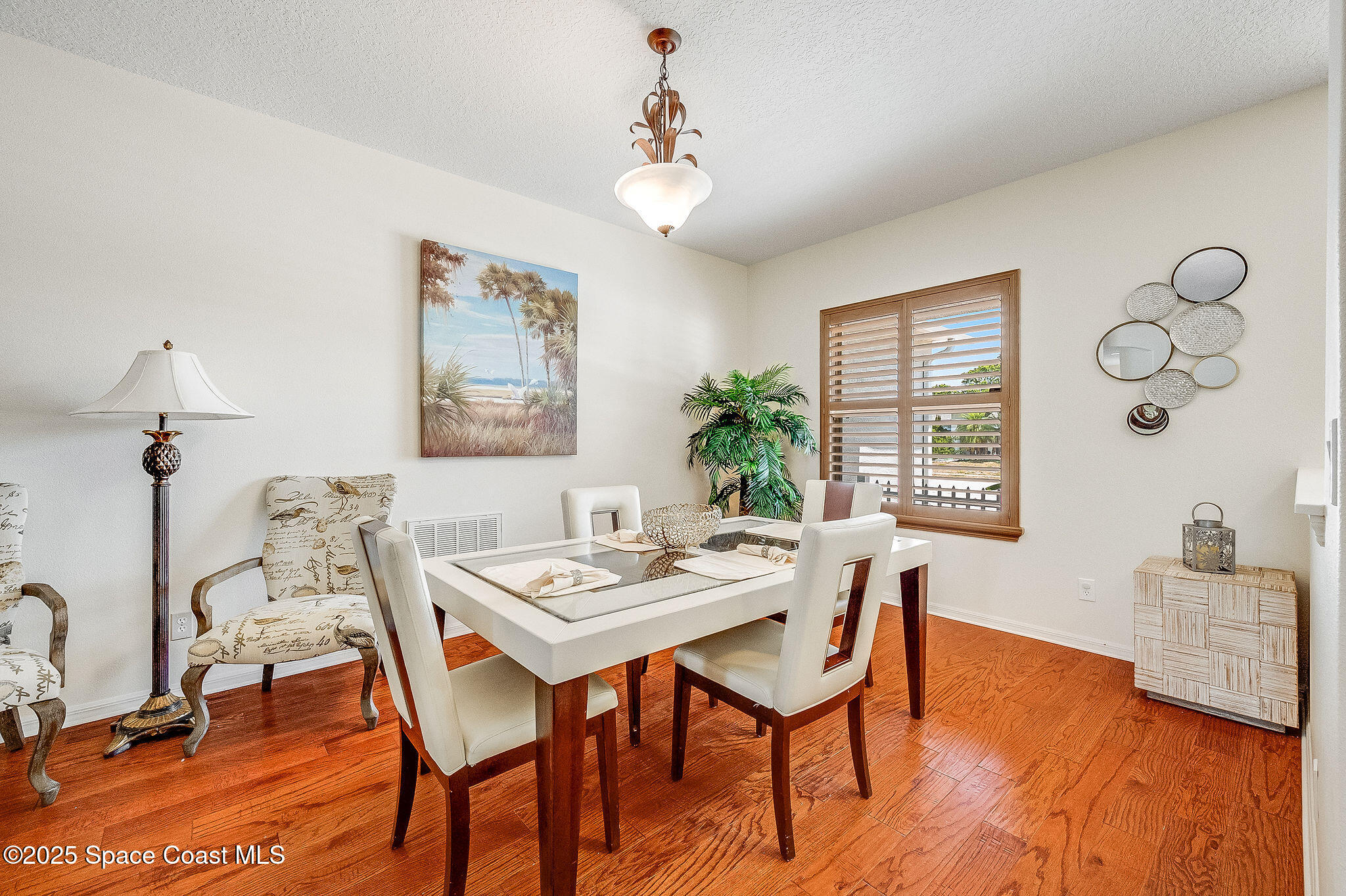 1137 Morgan Circle Northeast Palm Bay, FL 32905 - Photo 11 of 64 a view of a dining room with furniture window and wooden floor