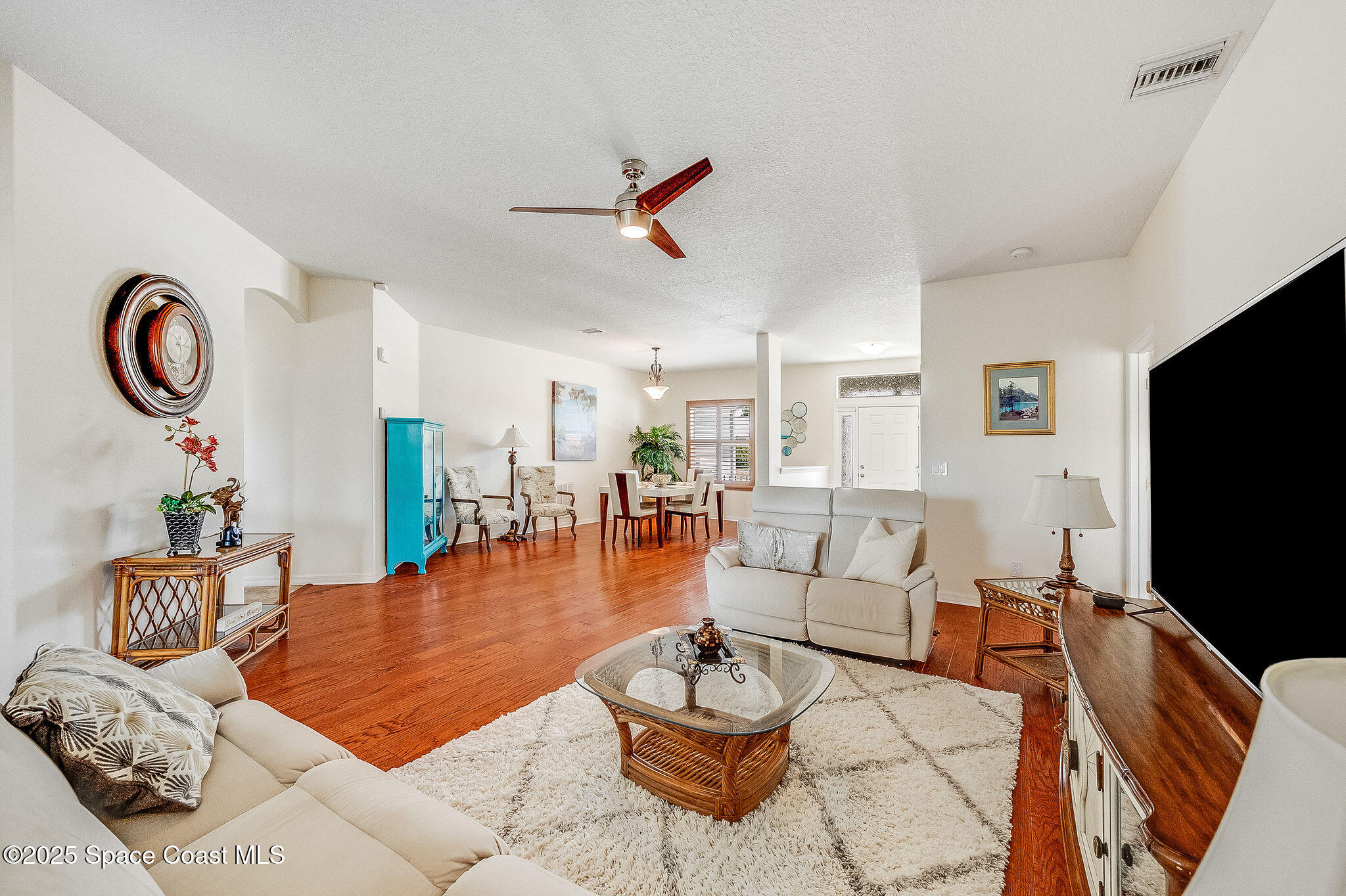 1137 Morgan Circle Northeast Palm Bay, FL 32905 - Photo 14 of 64 a living room with furniture and a flat screen tv