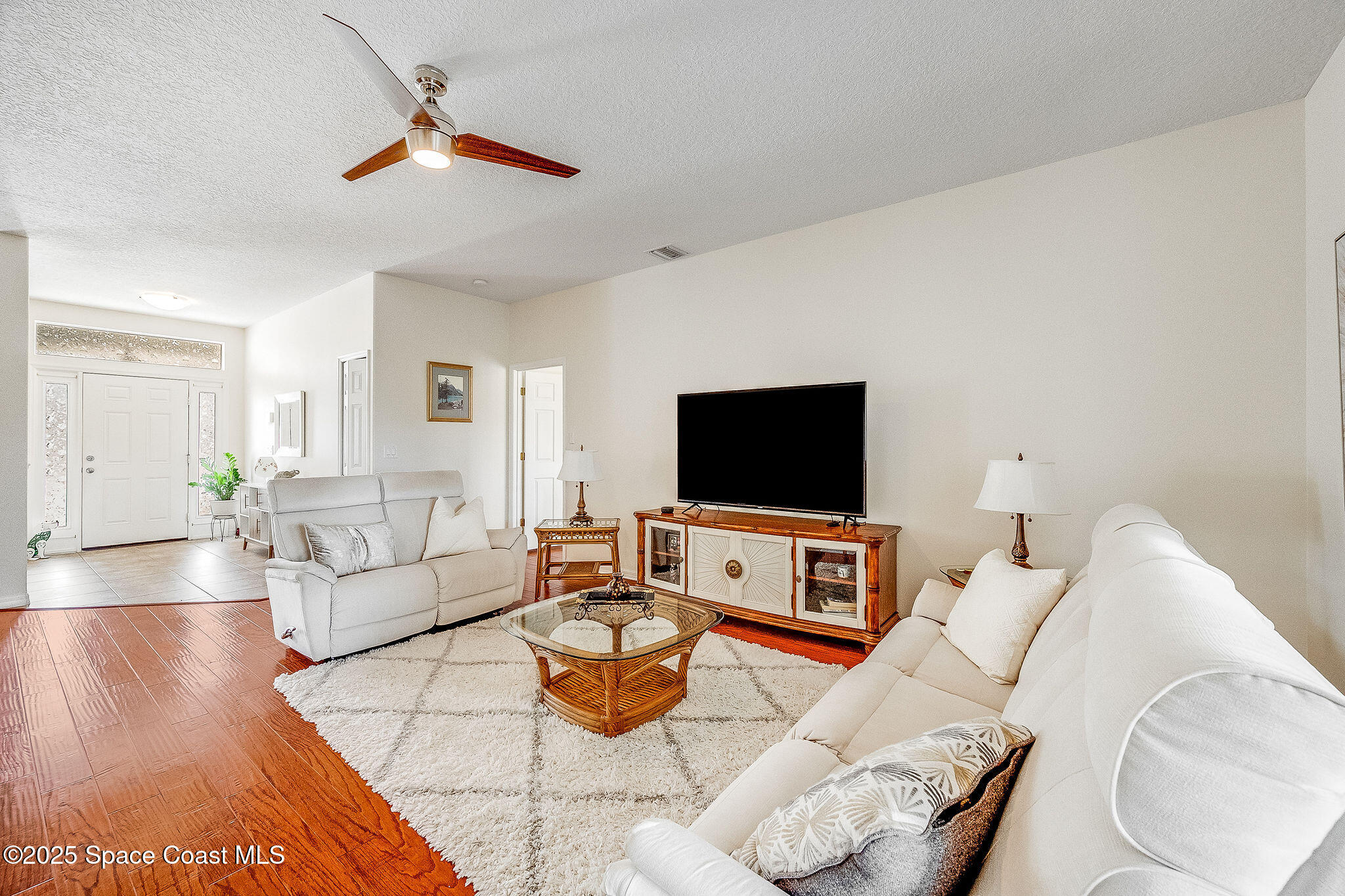 1137 Morgan Circle Northeast Palm Bay, FL 32905 - Photo 15 of 64 a living room with furniture and a flat screen tv