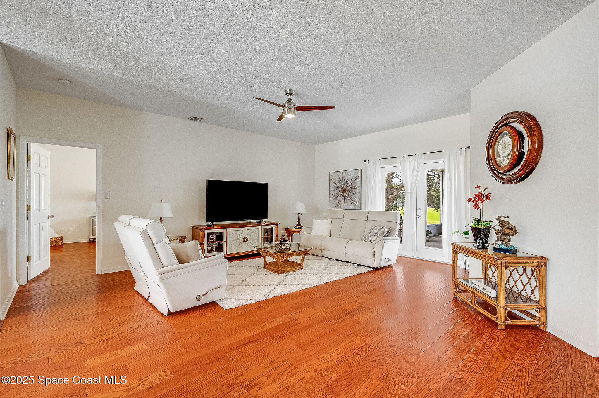 1137 Morgan Circle Northeast Palm Bay, FL 32905 - Photo 16 of 64 a living room with furniture and a flat screen tv