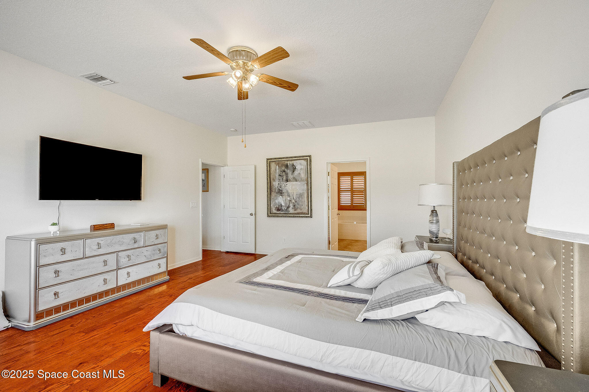 1137 Morgan Circle Northeast Palm Bay, FL 32905 - Photo 19 of 64 a bedroom with a bed and flat screen tv