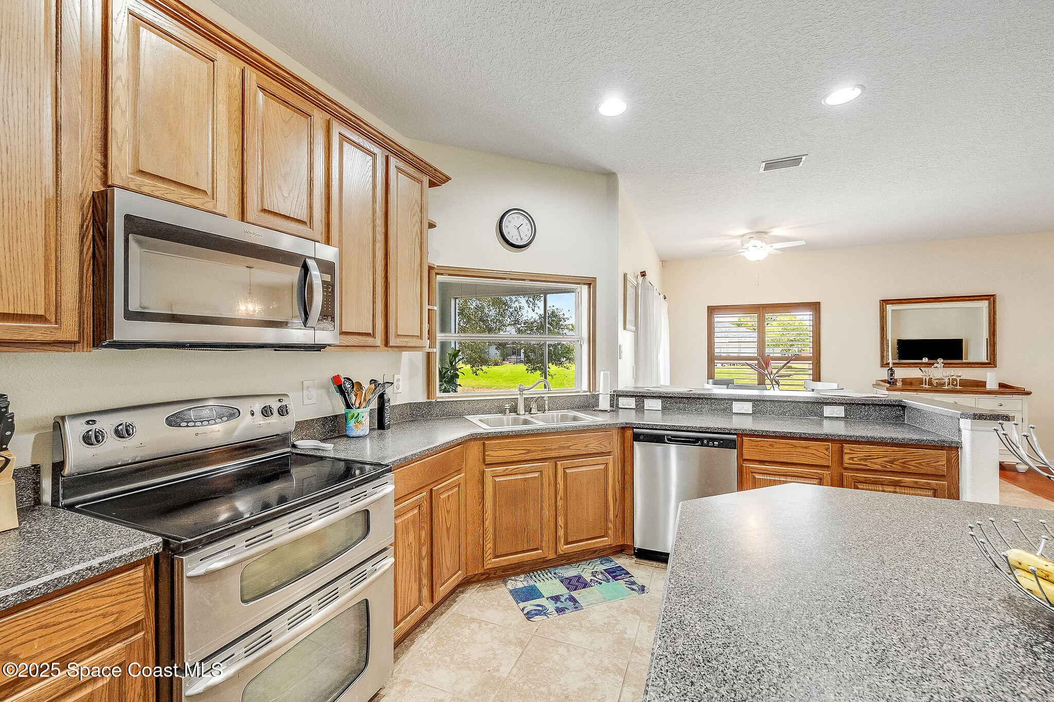 1137 Morgan Circle Northeast Palm Bay, FL 32905 - Photo 2 of 64 a kitchen with stainless steel appliances granite countertop a sink and stove top oven