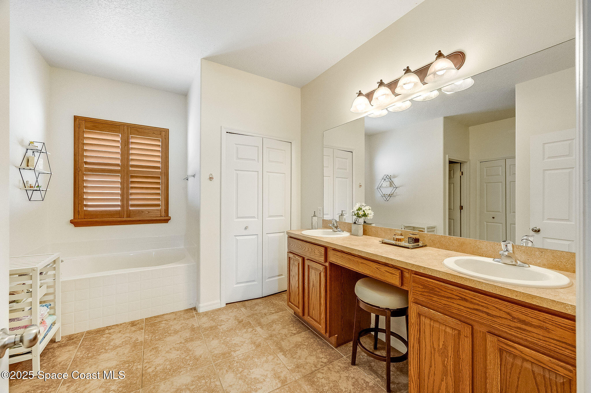 1137 Morgan Circle Northeast Palm Bay, FL 32905 - Photo 20 of 64 a bathroom with a sink a vanity and a mirror
