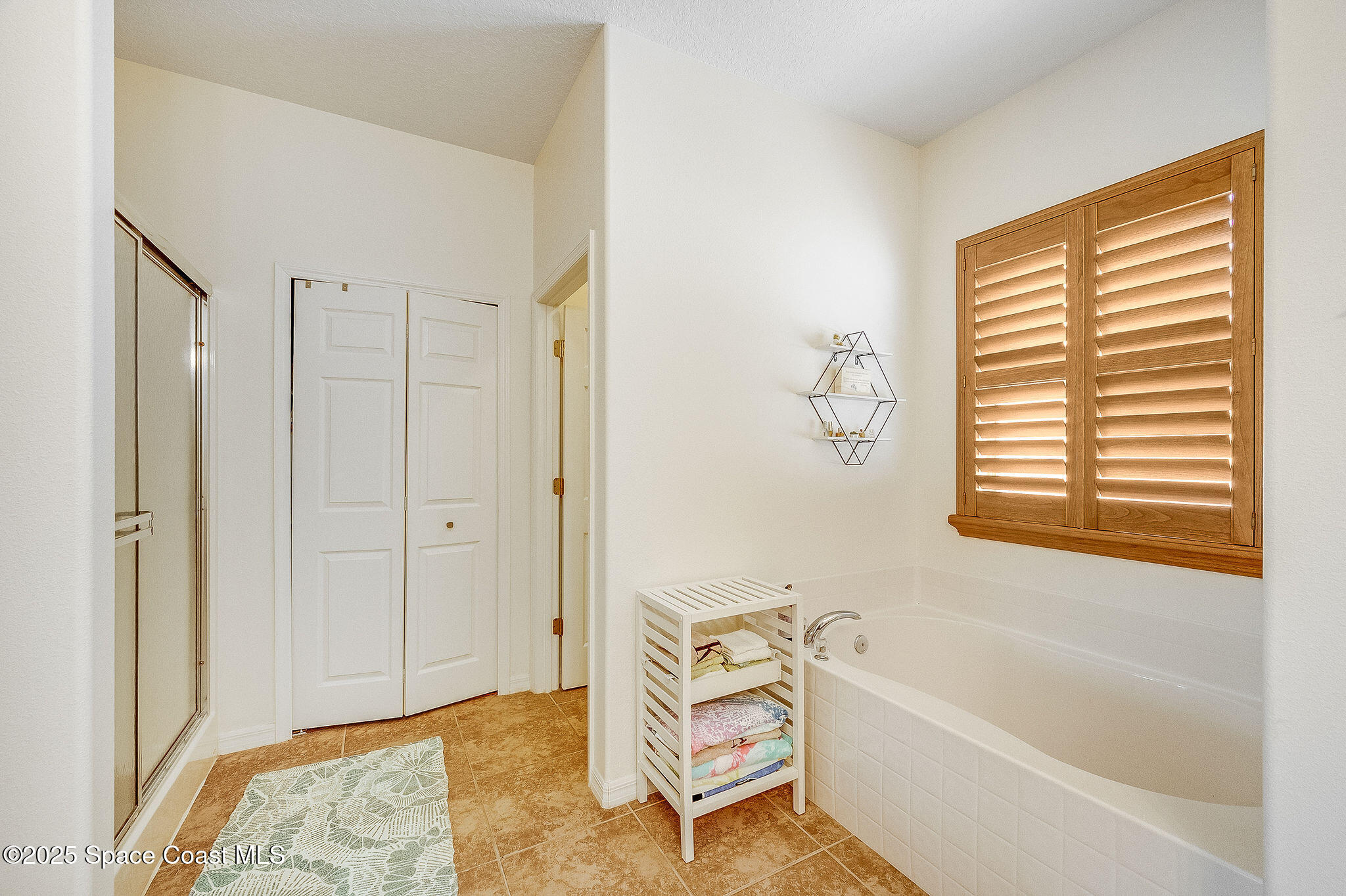 1137 Morgan Circle Northeast Palm Bay, FL 32905 - Photo 21 of 64 a bathroom with a bathtub and a shower