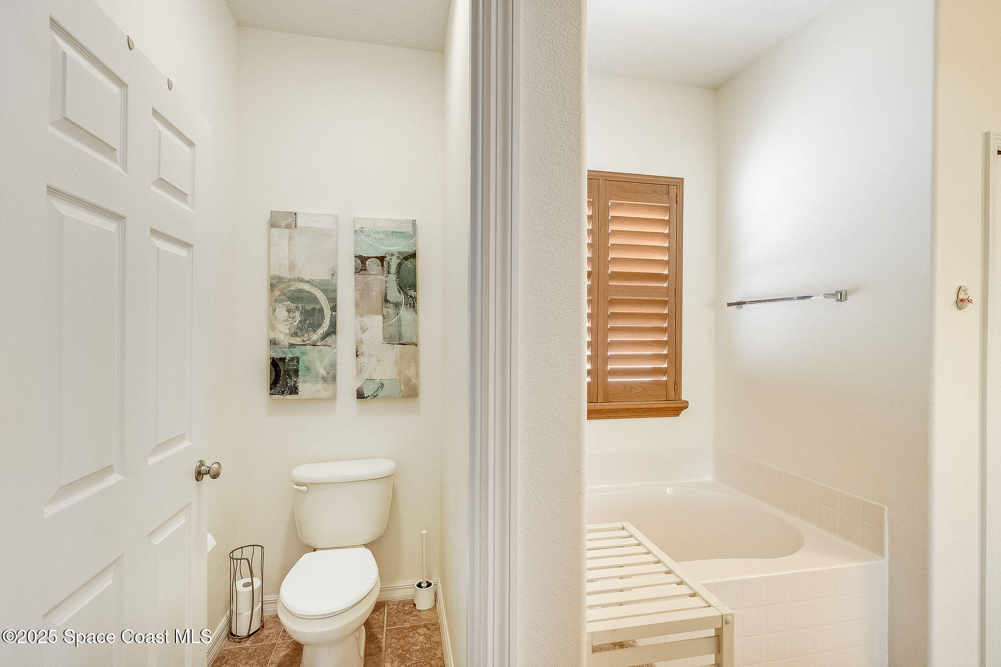 1137 Morgan Circle Northeast Palm Bay, FL 32905 - Photo 22 of 64 a bathroom with a toilet and a shower curtain