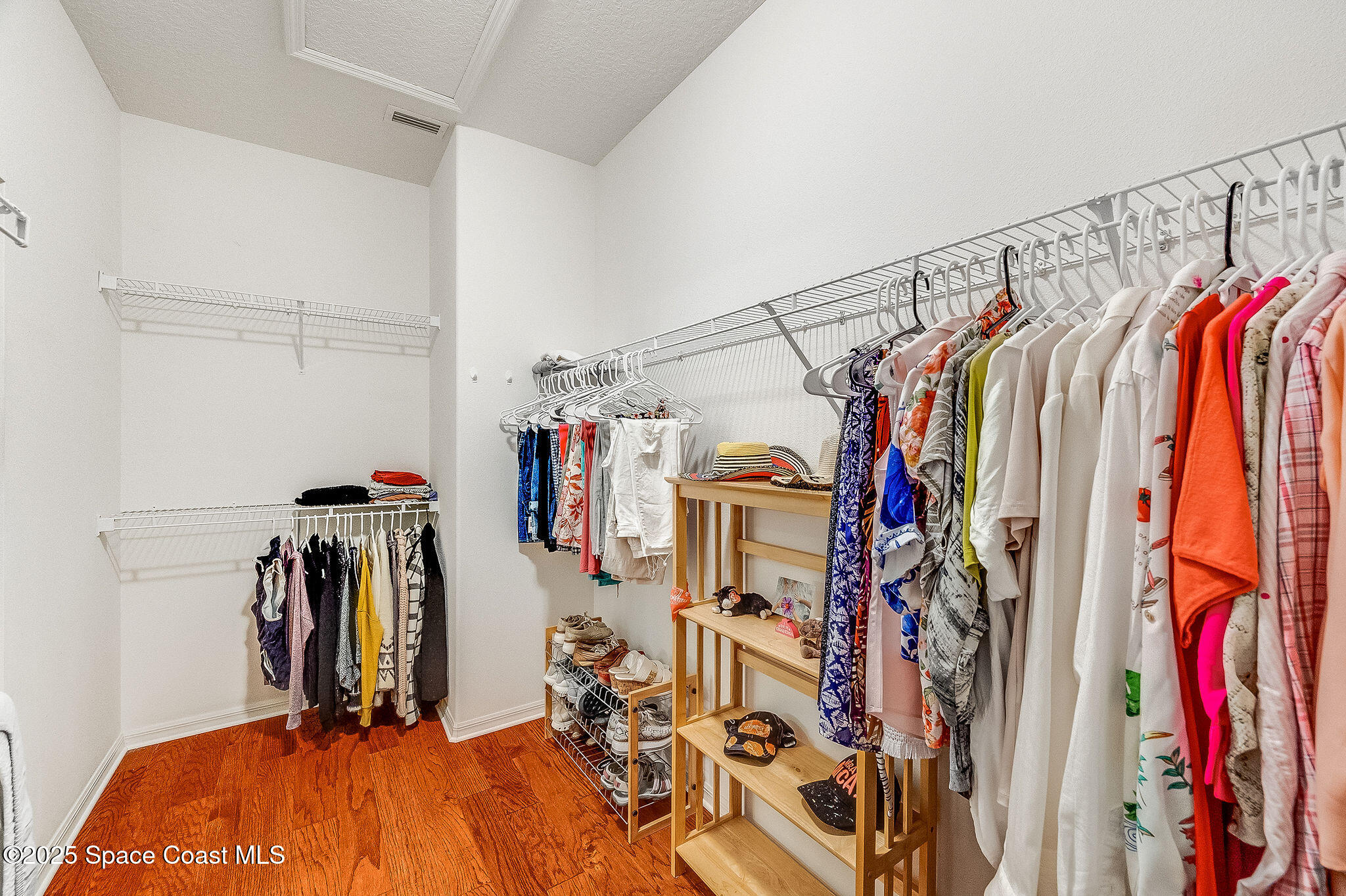 1137 Morgan Circle Northeast Palm Bay, FL 32905 - Photo 24 of 64 a view of walk in closet with clothes and shoes