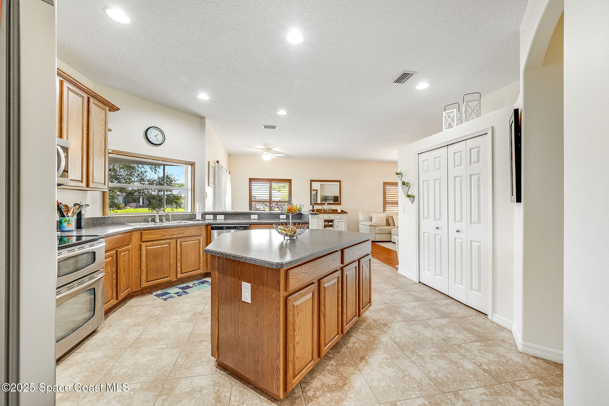 1137 Morgan Circle Northeast Palm Bay, FL 32905 - Photo 25 of 64 a large kitchen with stainless steel appliances granite countertop a large counter top and a stove
