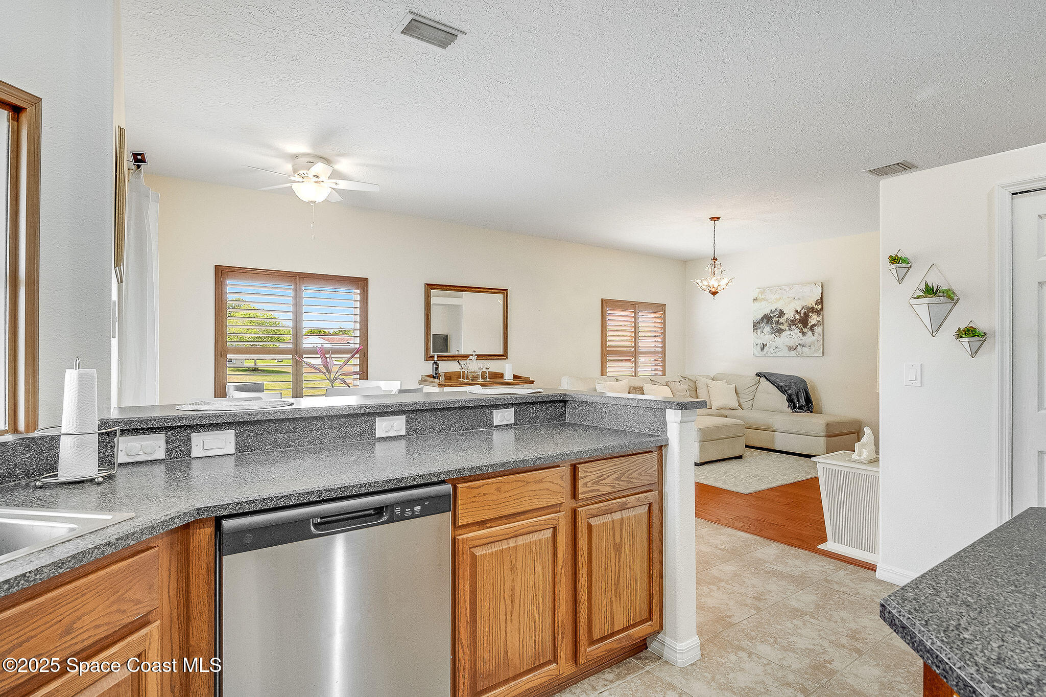 1137 Morgan Circle Northeast Palm Bay, FL 32905 - Photo 27 of 64 a kitchen with stainless steel appliances granite countertop a sink and a granite counter tops with wooden floors