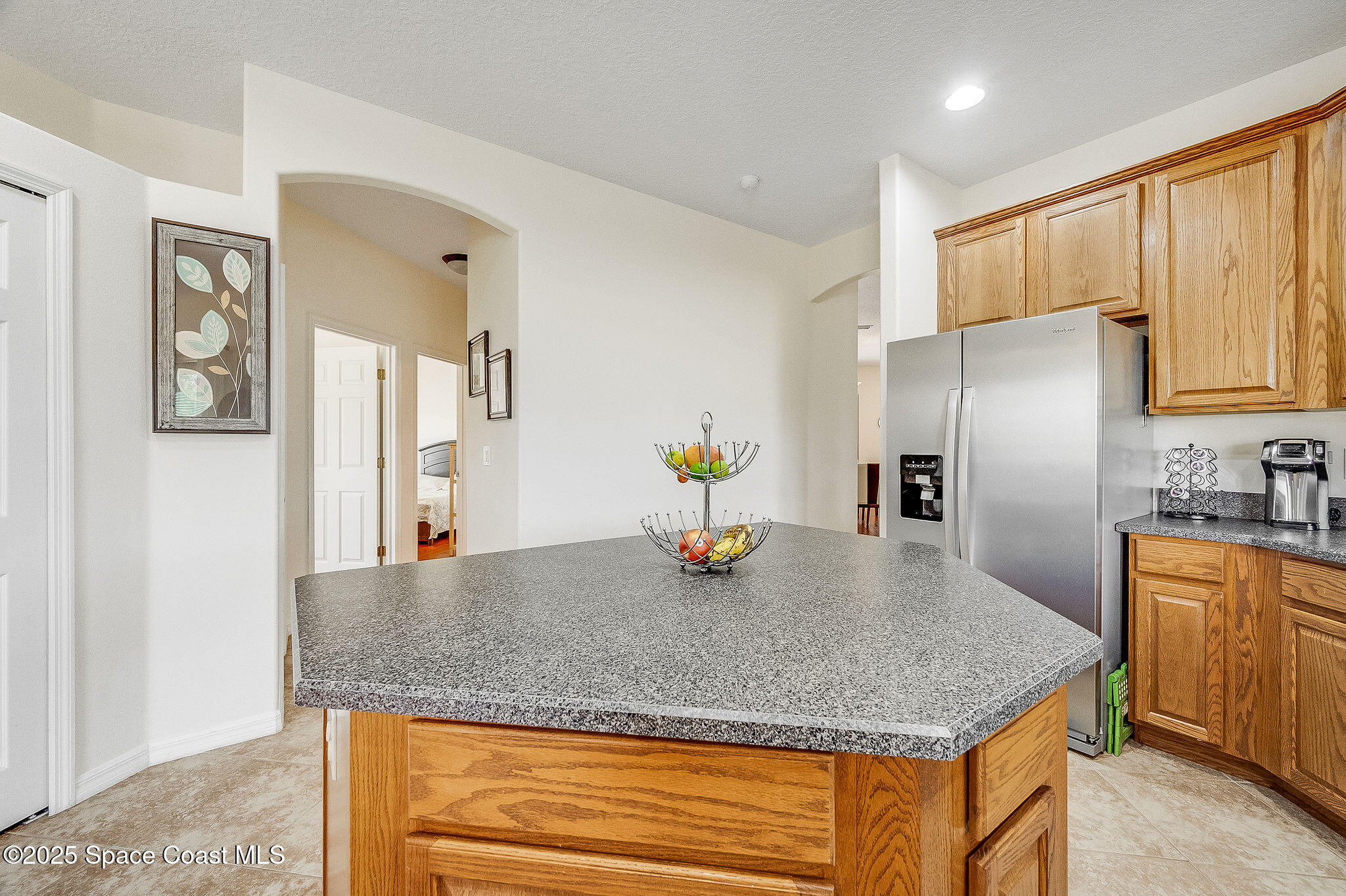 1137 Morgan Circle Northeast Palm Bay, FL 32905 - Photo 31 of 64 a kitchen with stainless steel appliances granite countertop a refrigerator a stove and a sink