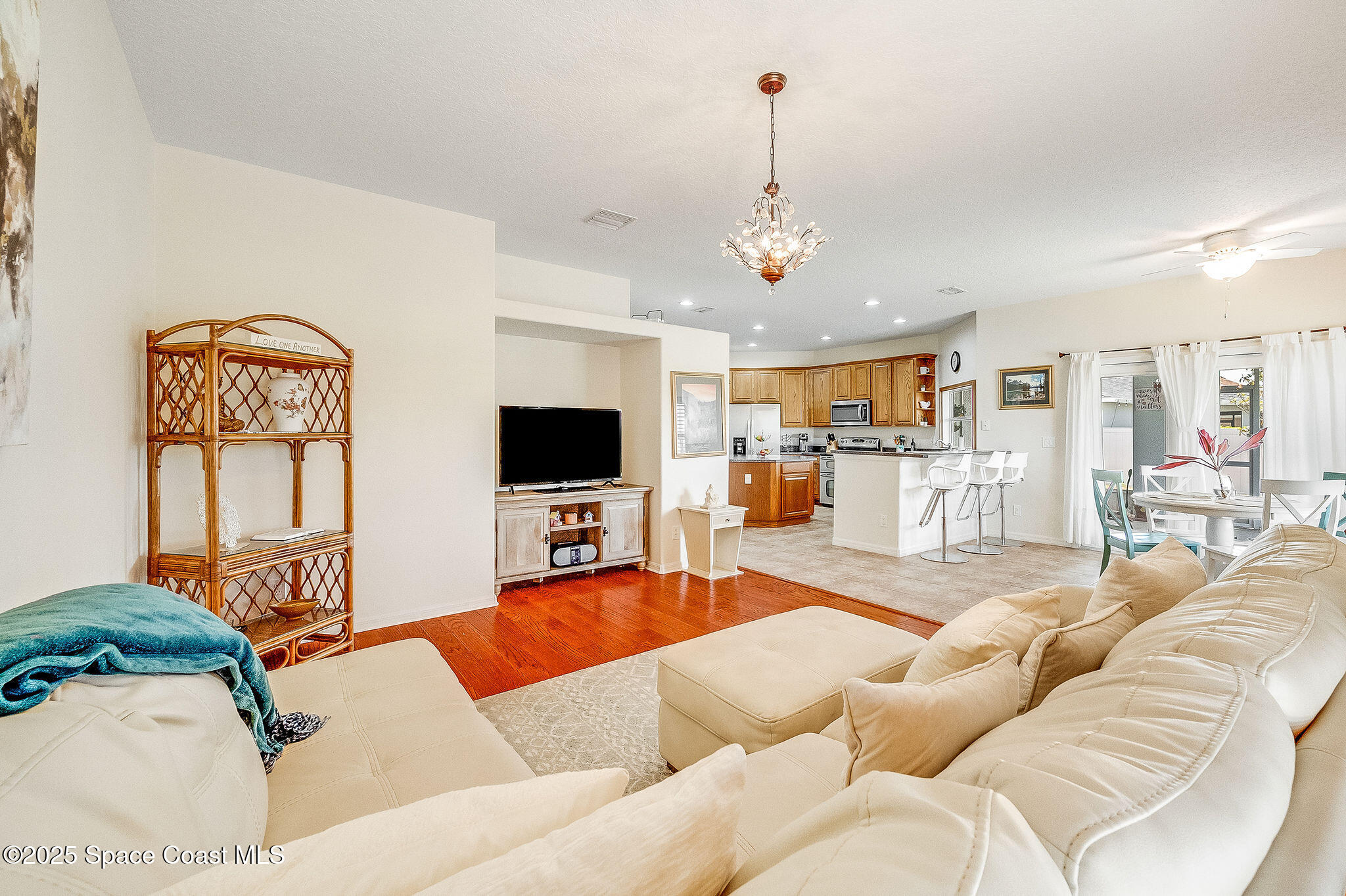 1137 Morgan Circle Northeast Palm Bay, FL 32905 - Photo 35 of 64 a living room with furniture kitchen view and a flat screen tv
