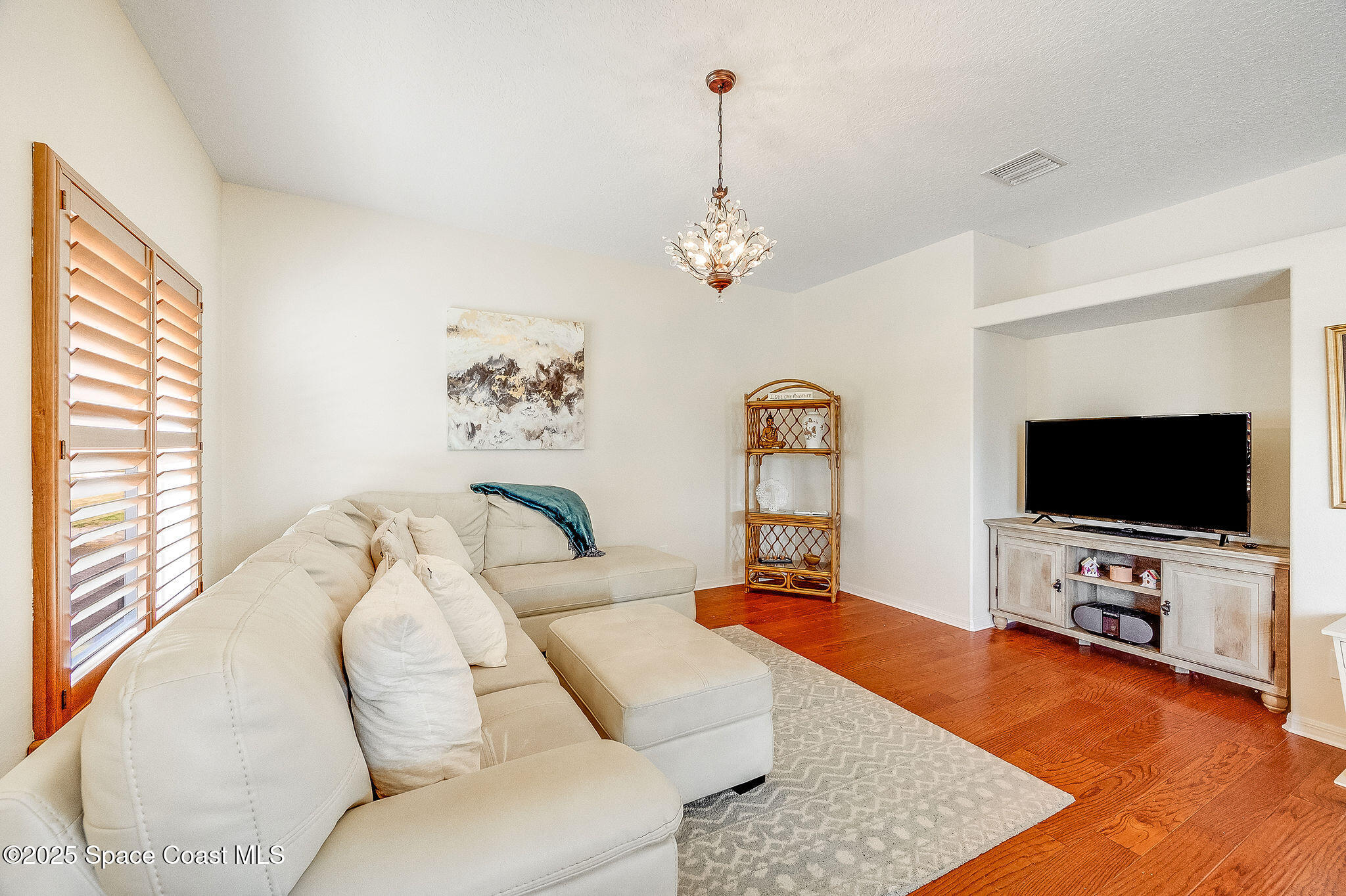 1137 Morgan Circle Northeast Palm Bay, FL 32905 - Photo 36 of 64 a living room with furniture and a flat screen tv