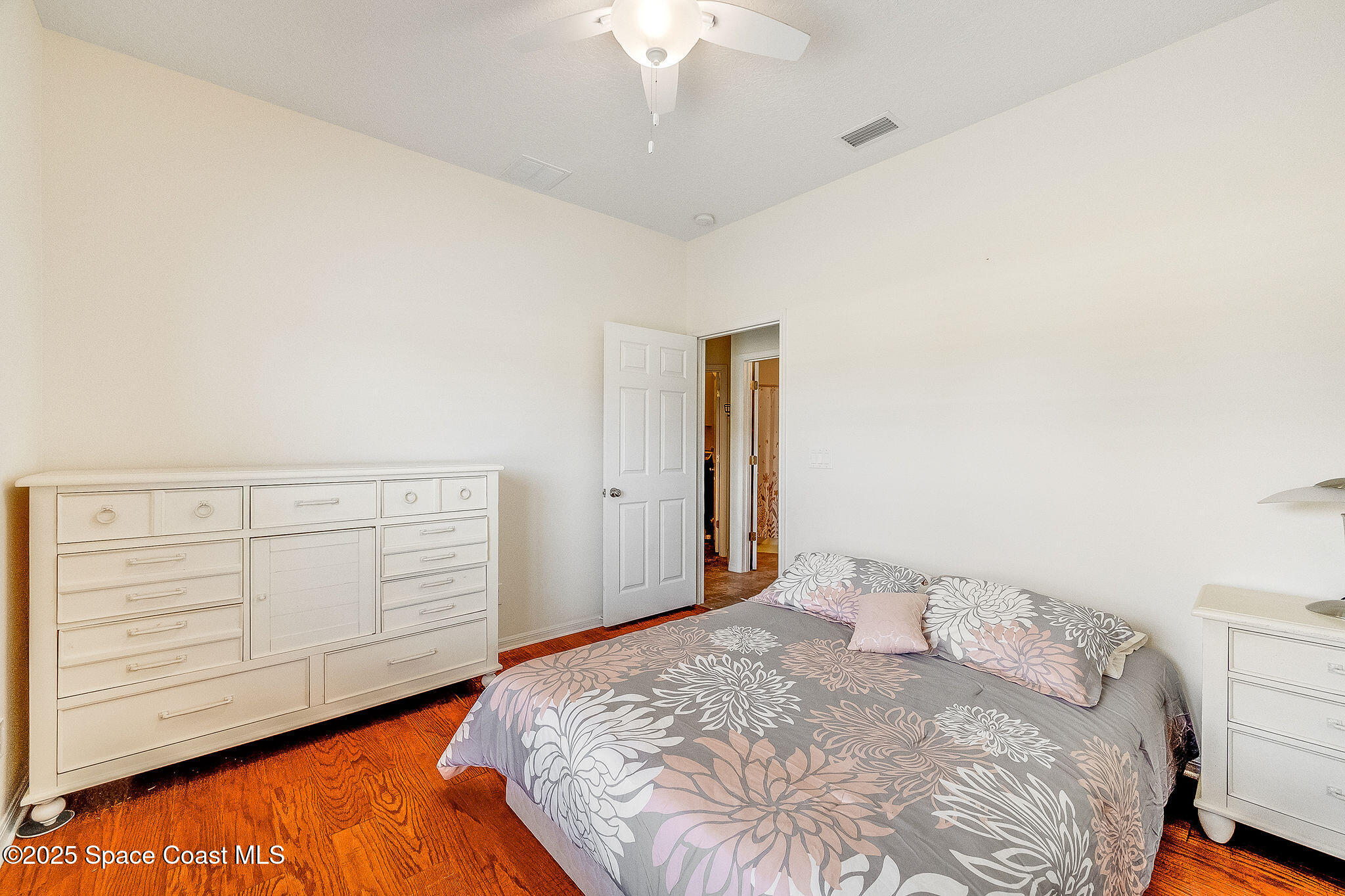 1137 Morgan Circle Northeast Palm Bay, FL 32905 - Photo 42 of 64 a bedroom with a bed and a dresser