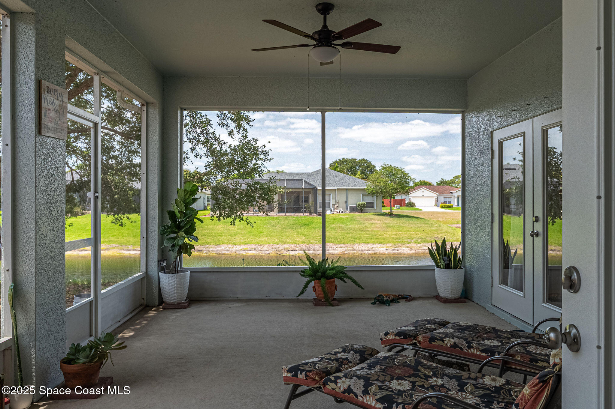 1137 Morgan Circle Northeast Palm Bay, FL 32905 - Photo 50 of 64 a room with furniture and a floor to ceiling window