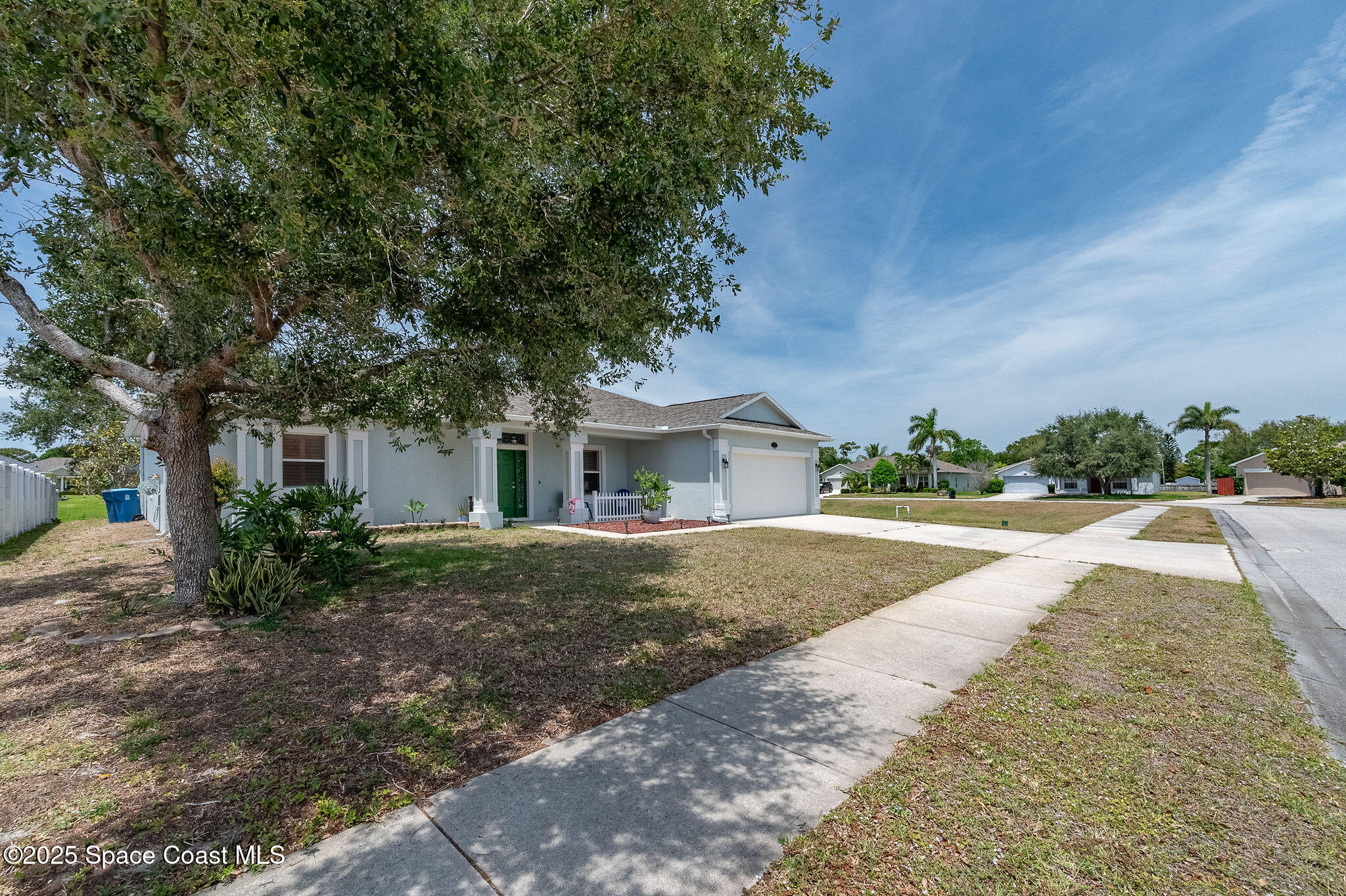 1137 Morgan Circle Northeast Palm Bay, FL 32905 - Photo 52 of 64 a front view of a house with a yard and garage