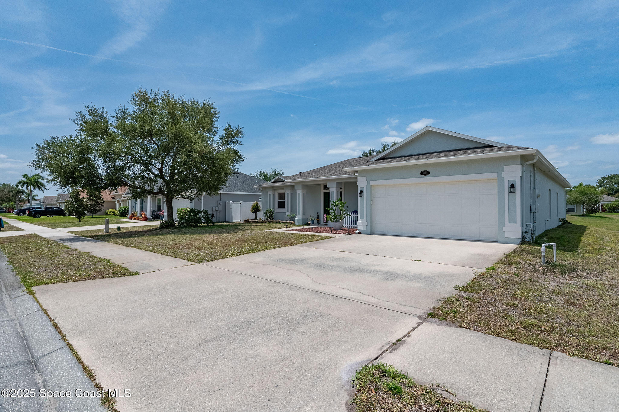 1137 Morgan Circle Northeast Palm Bay, FL 32905 - Photo 55 of 64 a front view of a house with a yard and garage