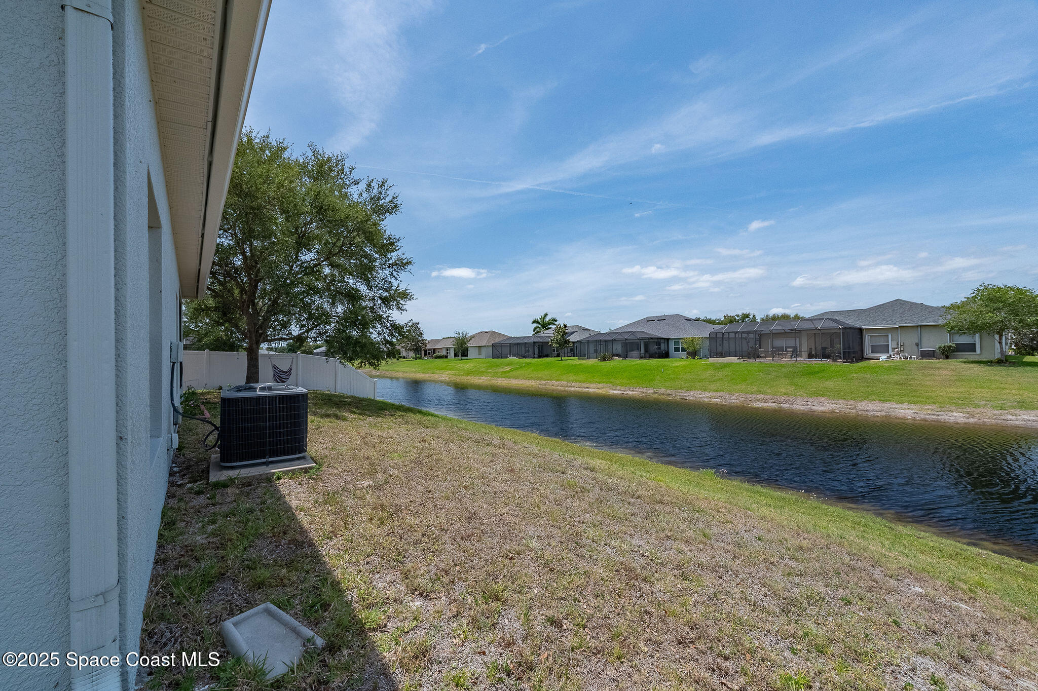 1137 Morgan Circle Northeast Palm Bay, FL 32905 - Photo 57 of 64 a view of a lake with a yard