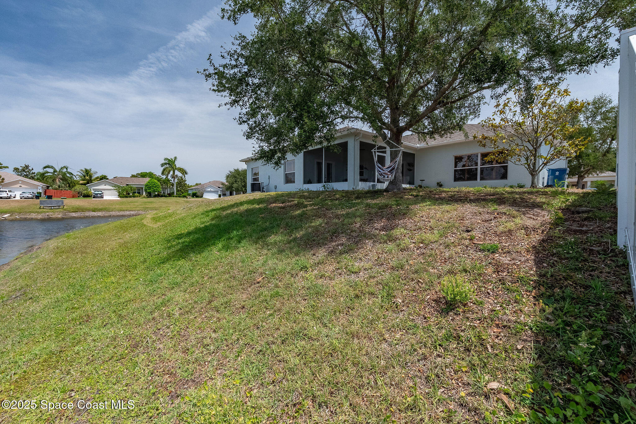 1137 Morgan Circle Northeast Palm Bay, FL 32905 - Photo 59 of 64 a front view of a house with a garden