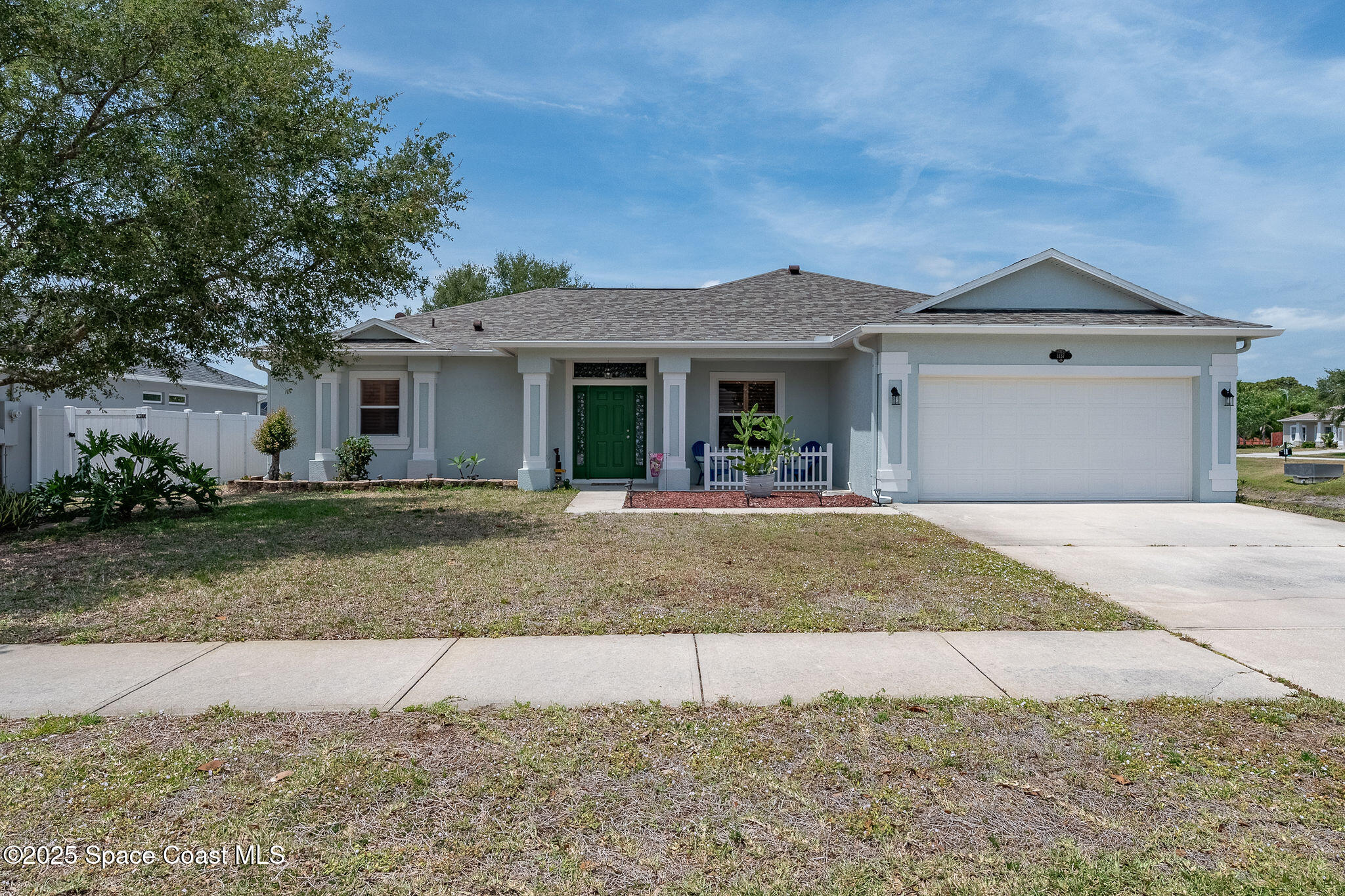 1137 Morgan Circle Northeast Palm Bay, FL 32905 - Photo 5 of 64 a front view of a house with yard