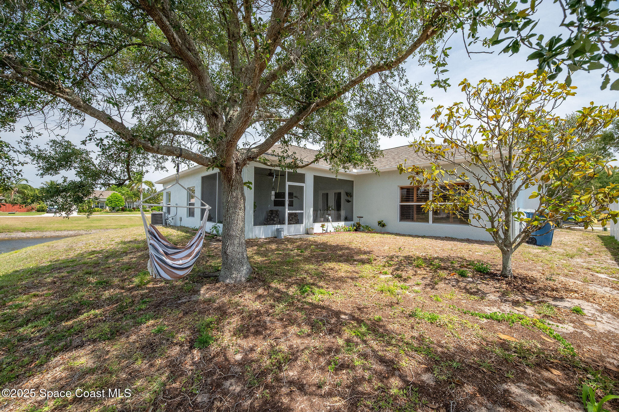 1137 Morgan Circle Northeast Palm Bay, FL 32905 - Photo 60 of 64 a view of a house with backyard of house