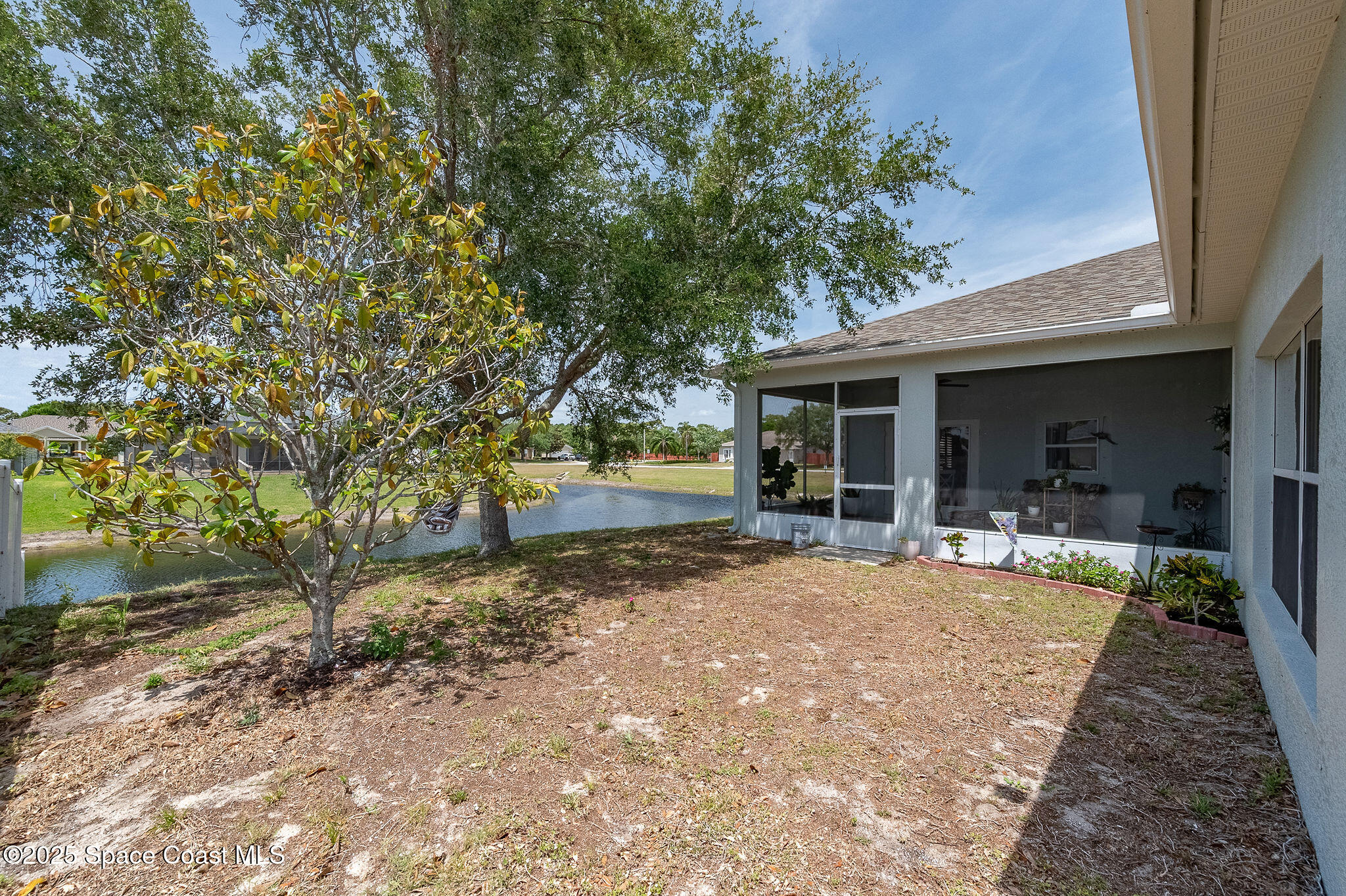 1137 Morgan Circle Northeast Palm Bay, FL 32905 - Photo 61 of 64 a front view of a house with garden and patio