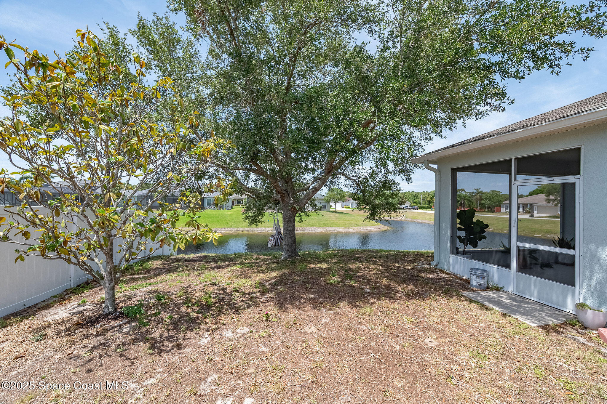 1137 Morgan Circle Northeast Palm Bay, FL 32905 - Photo 63 of 64 a view of a yard with plants and trees