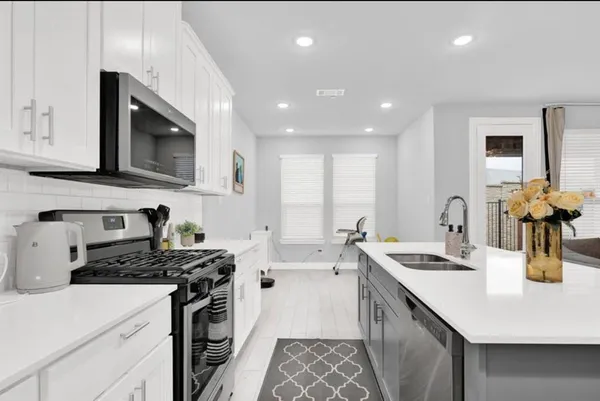 a kitchen that has a sink and a stove