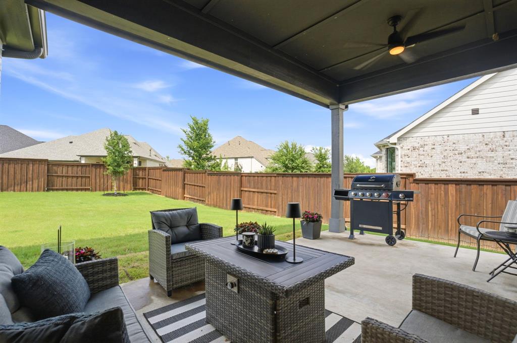1632 Cotton Road Van Alstyne, TX 75495 - Photo 23 of 40 a view of a patio with couches chairs dining table and chairs with wooden floor